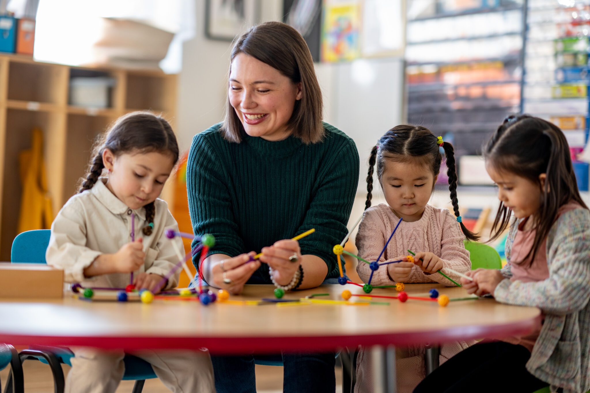 Teacher and children doing crafts together